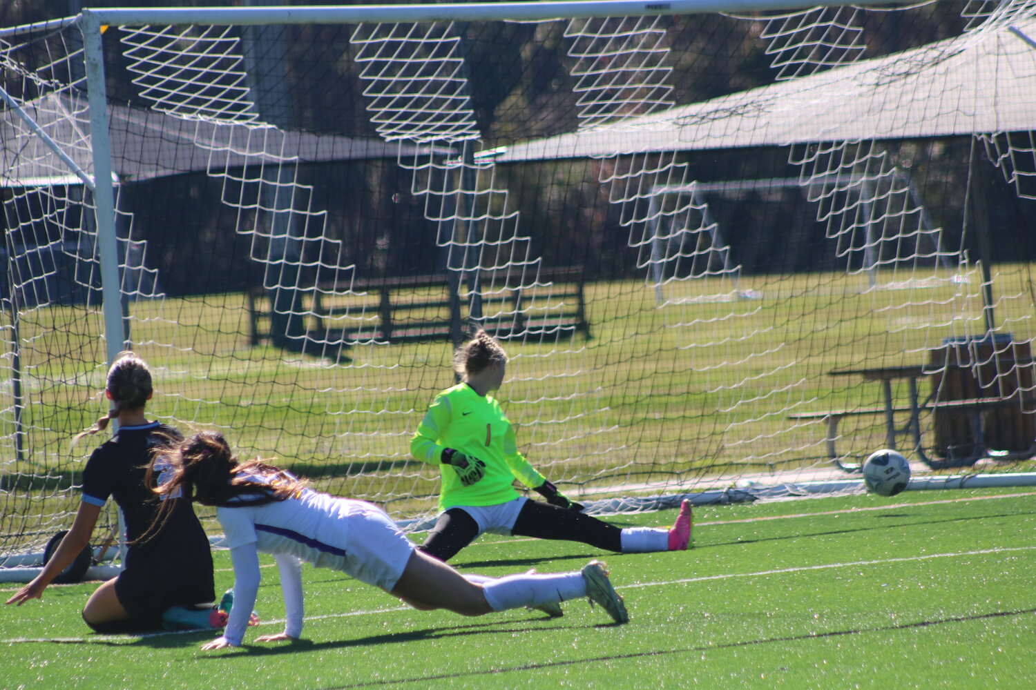 The Monteverde goalkeeper can only watch the ball fly by her after a shot by Natalie Brooks.